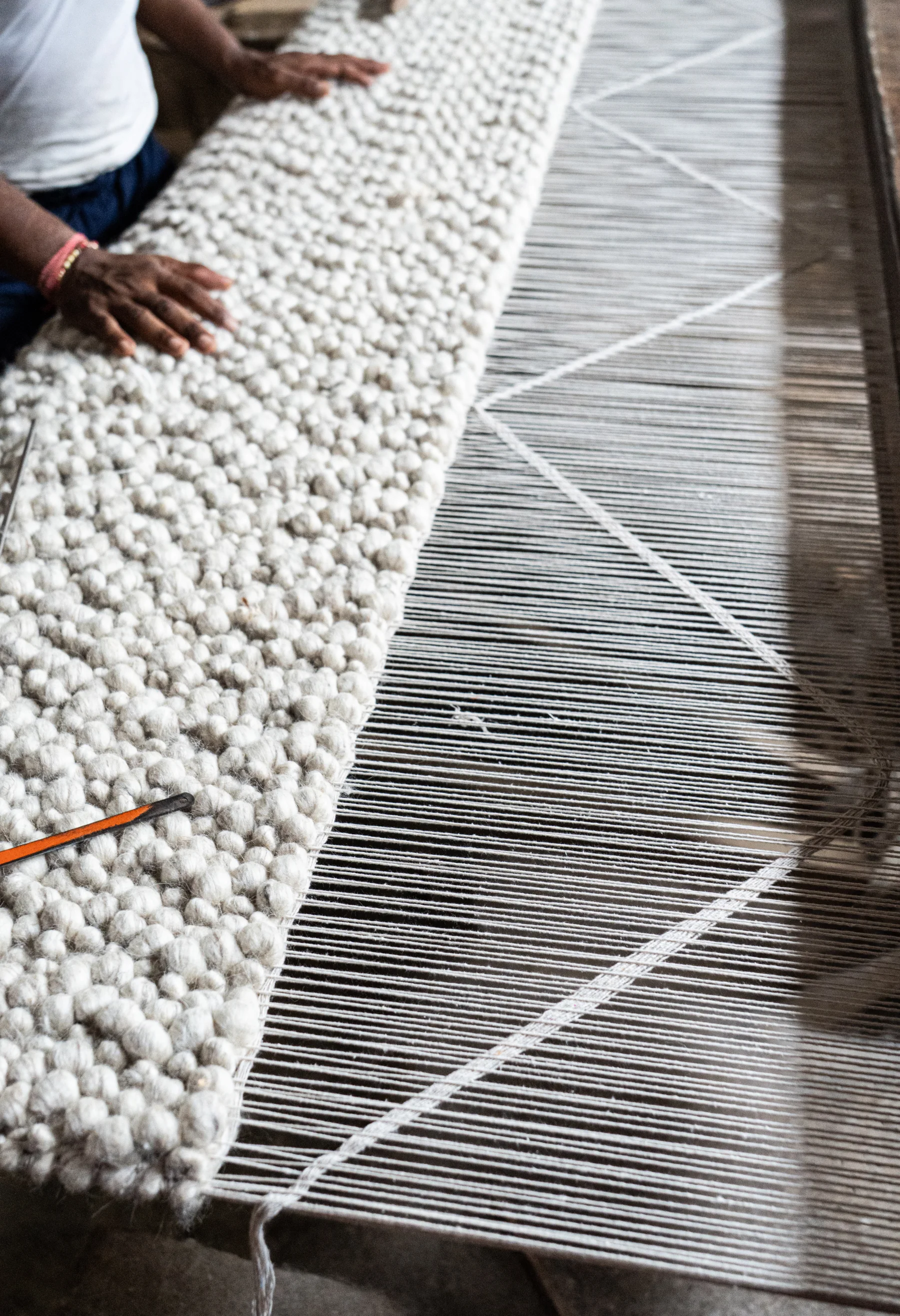 Hand-tufting detail during rug making
