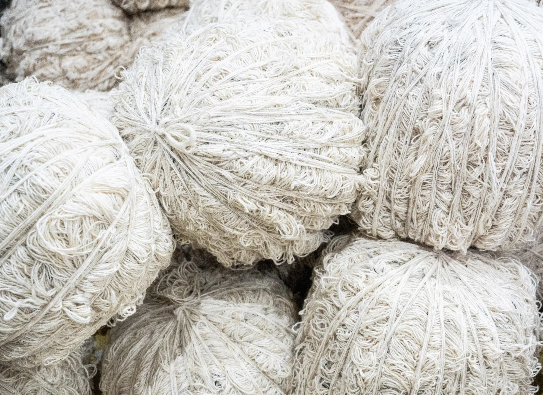 A soft wool rug beside a textured natural jute rug, showing the difference in fiber and surface