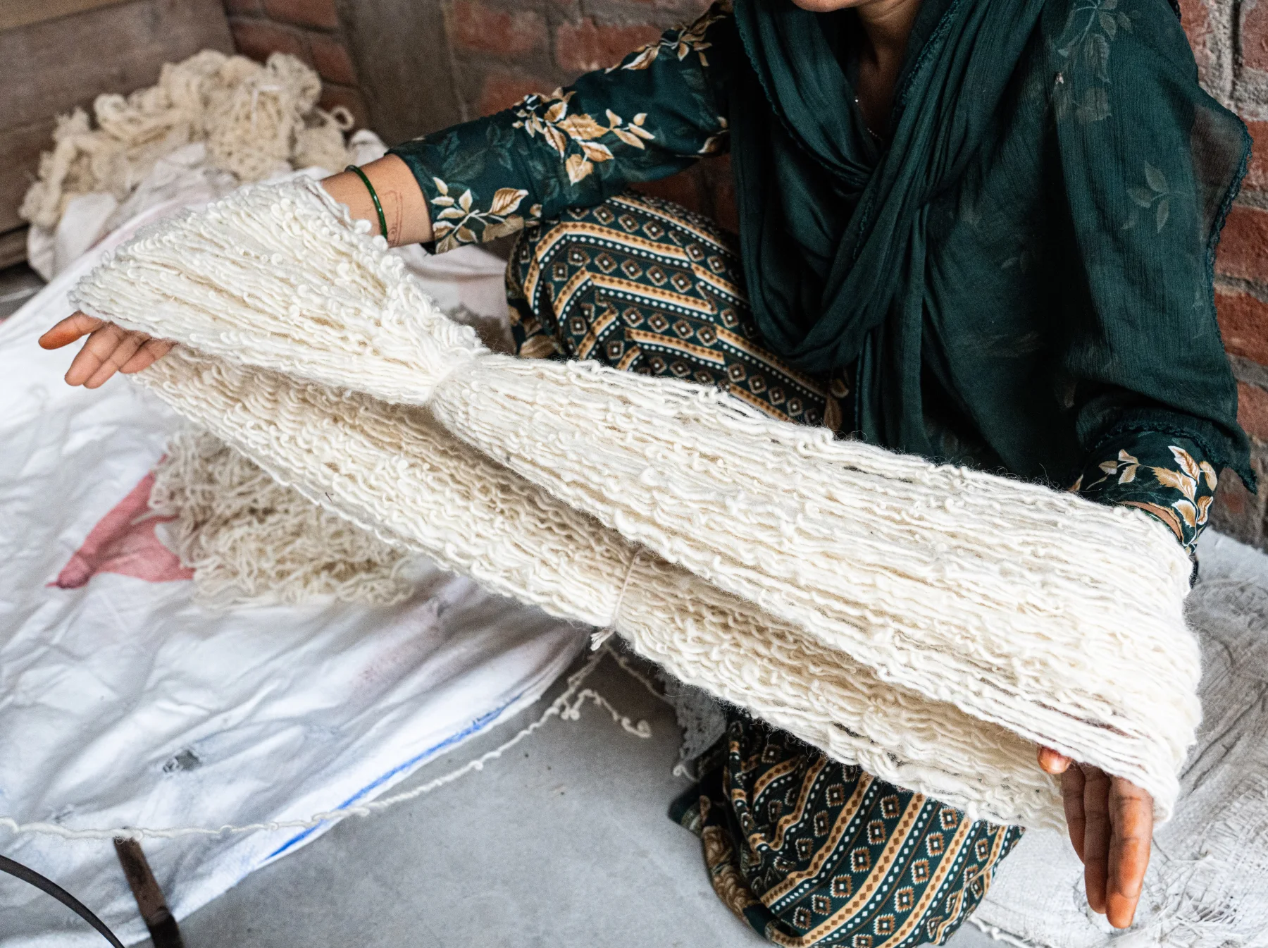 Artisan preparing wool for a handmade rug