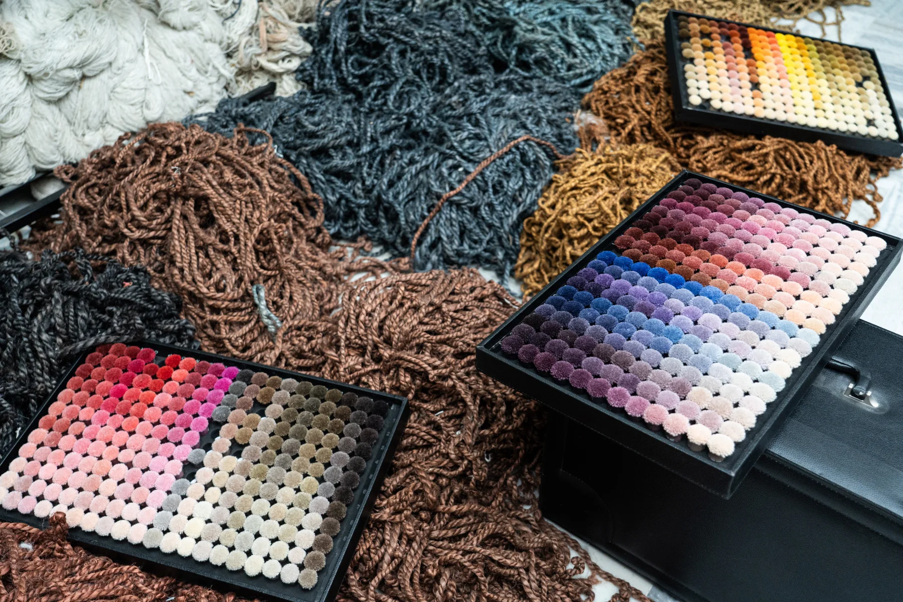 Wool yarns and colour samples for a custom rug