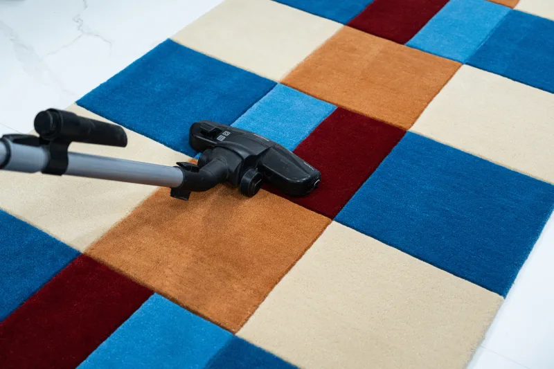 Vacuuming a hand-knotted wool rug with a suction-only attachment