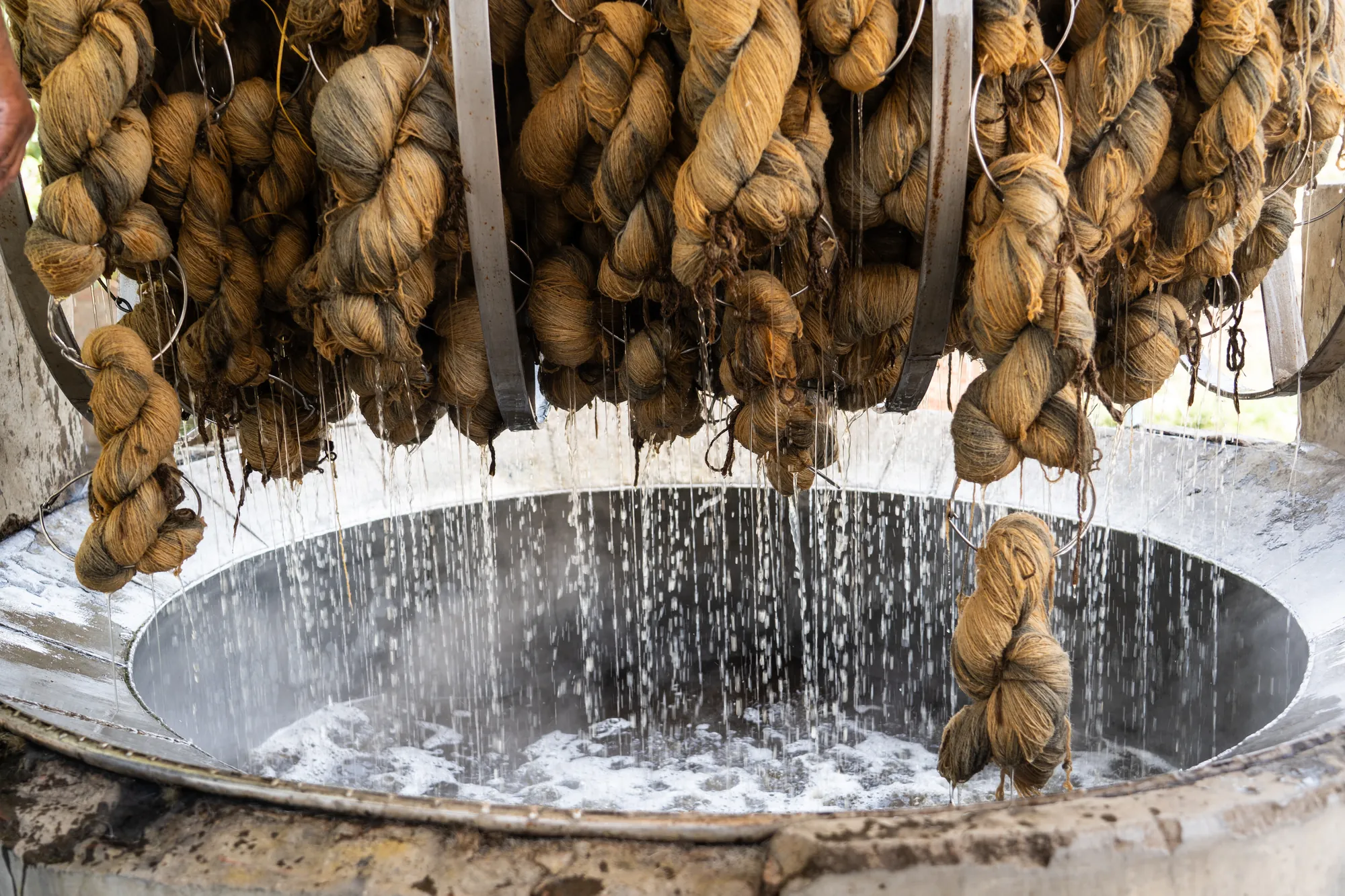 Washing freshly dyed yarn before weaving.